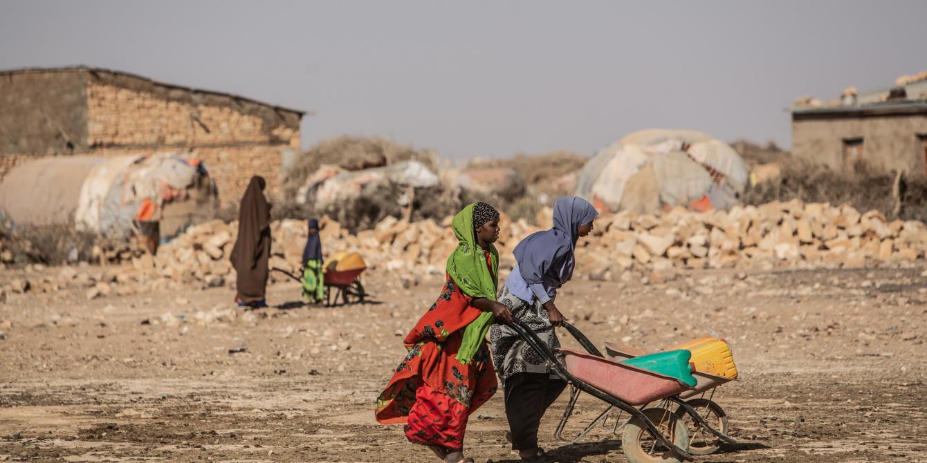 Women walk carrying a water jerry can in the Eilmidgan Village, eastern Somaliland. Pablo Tosco/Oxfam